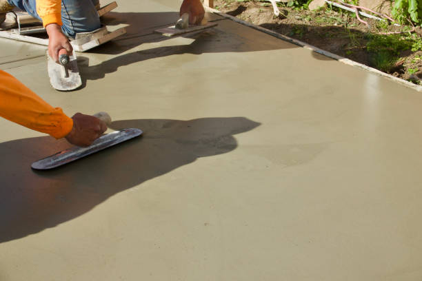 construction workers putting finishing touch on the freshly poured concrete